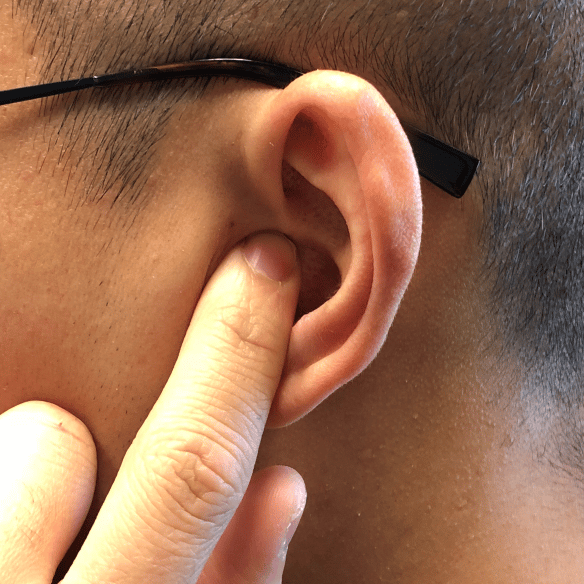 Demonstration of touching the tragus with a fingertip