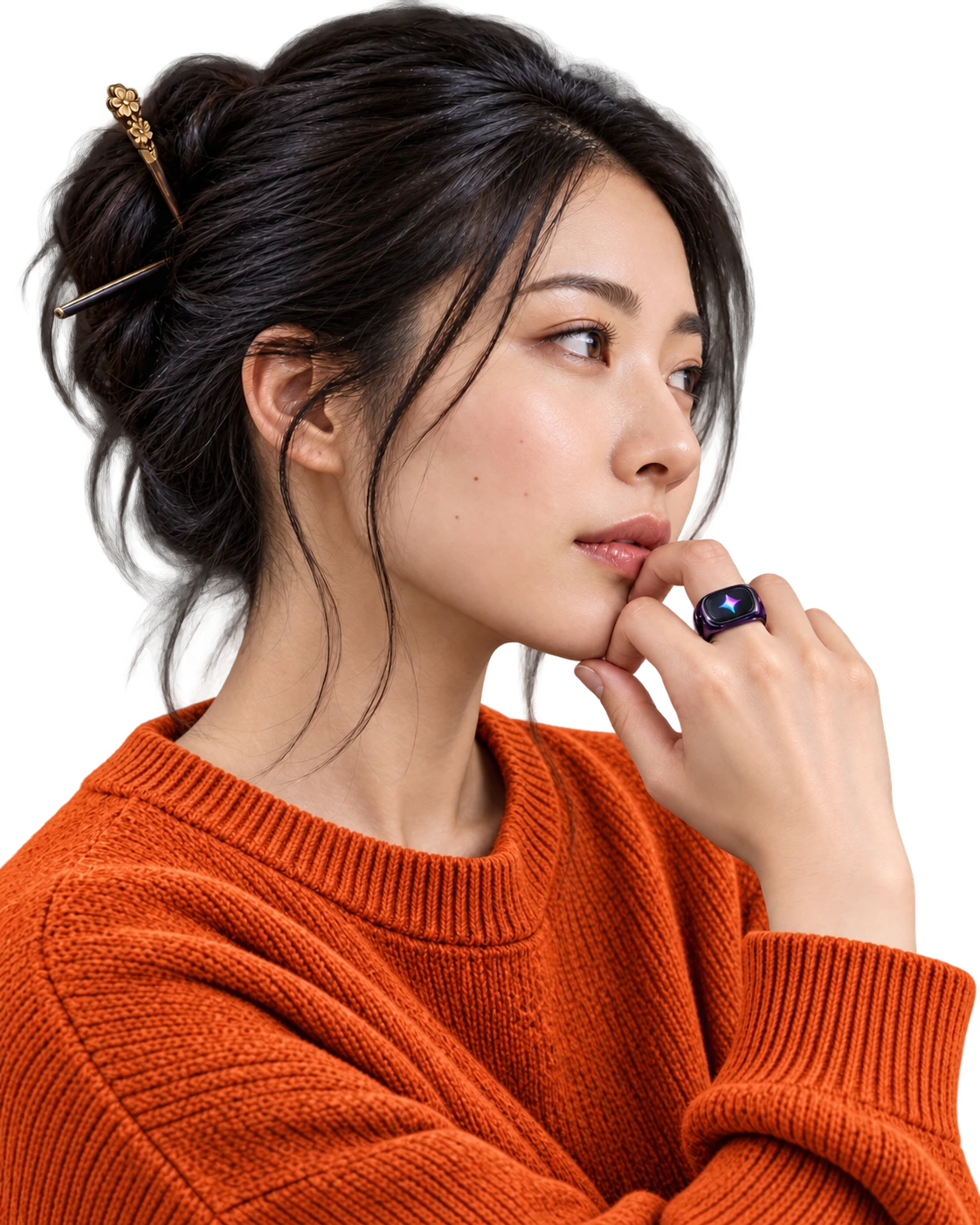 Woman in an orange knit sweater wearing a purple Soliman Ring near her chin